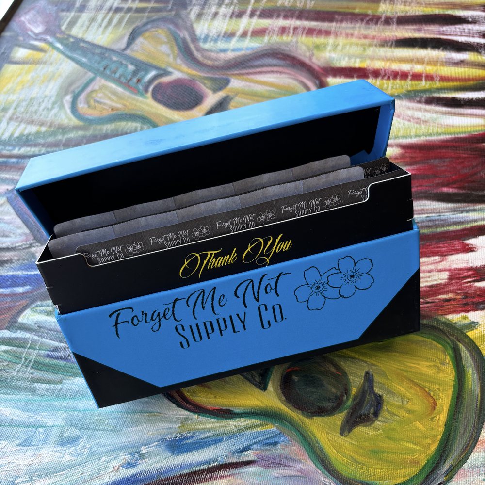 Open Forget Me Not Supply Co. box with a 'Thank You' insert and cartridge packs inside